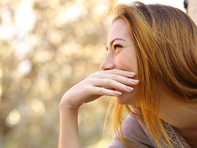 A woman laughing.