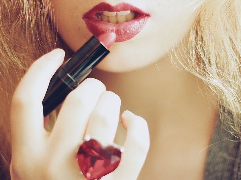 A cougar putting on lipstick.