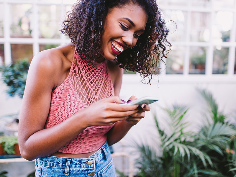 The guy texting this girl learned how to make a girl laugh over text. She's cracking up.