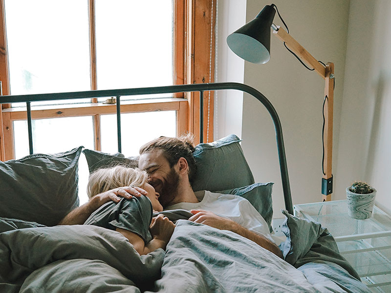 A couple using one of these ways to say good morning and good morning quotes while in bed kissing.