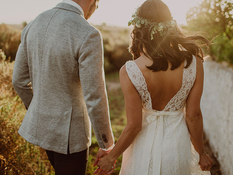 A couple who found out that marriage was right for them holding hands at their wedding.