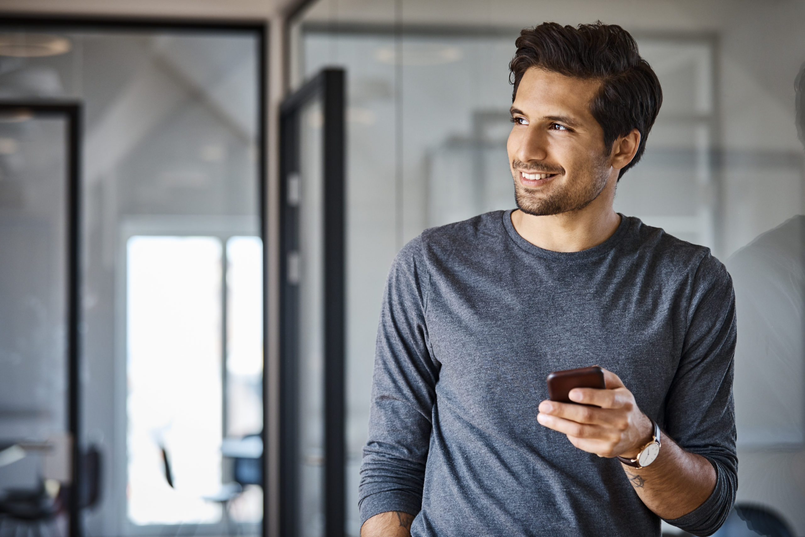 attractive single man using mobile for gay dating apps