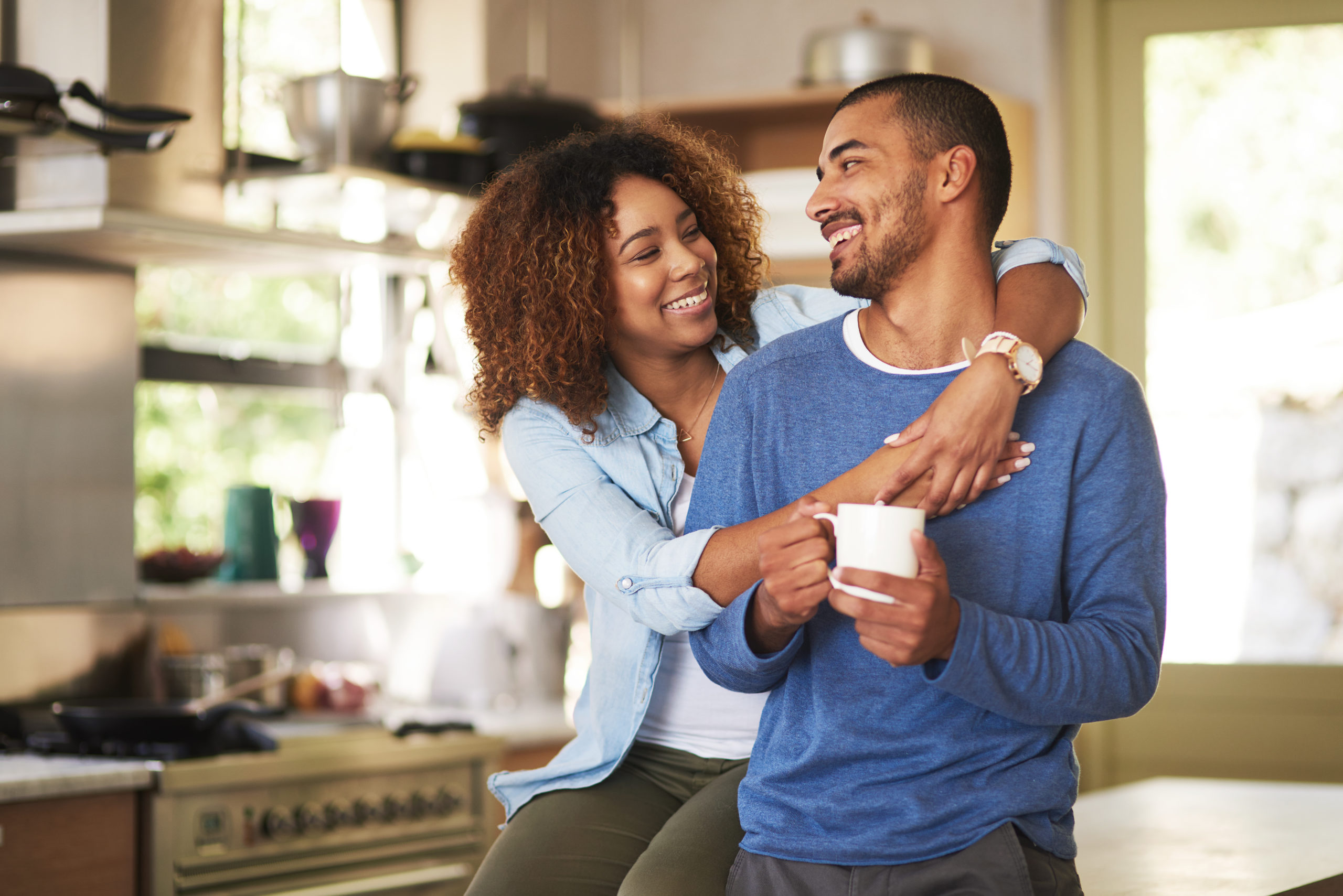 Happy couple smiling and embracing each other after meeting online on a black dating site.