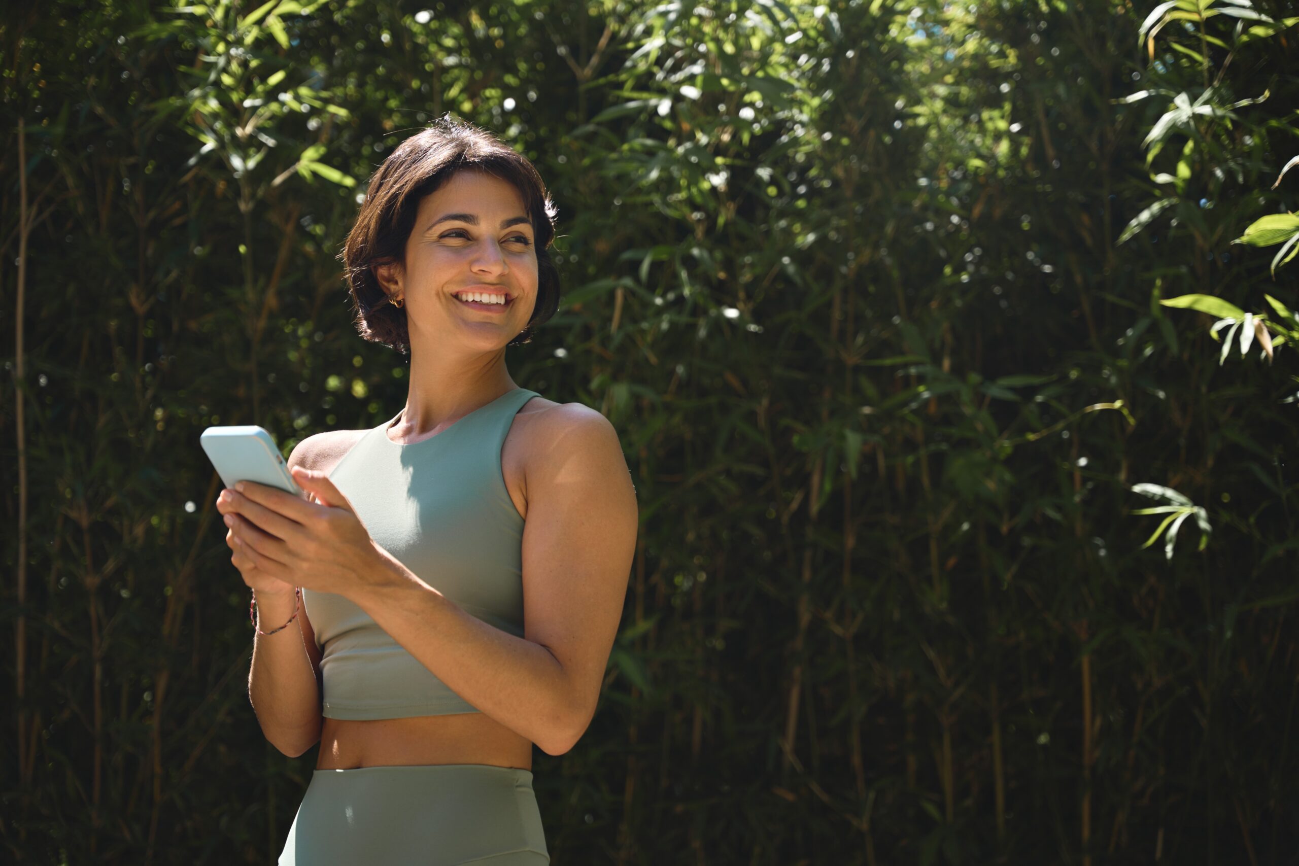 Woman smiling while checking her phone.